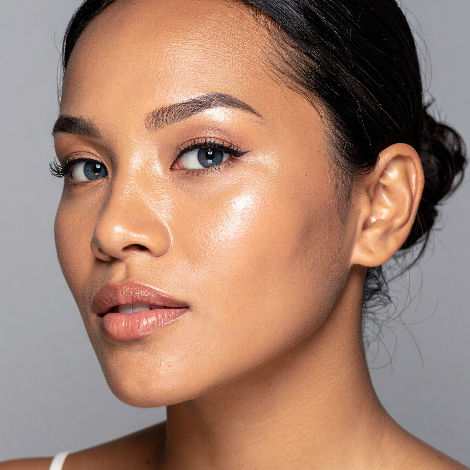 Close-up of a woman's face with a neutral background